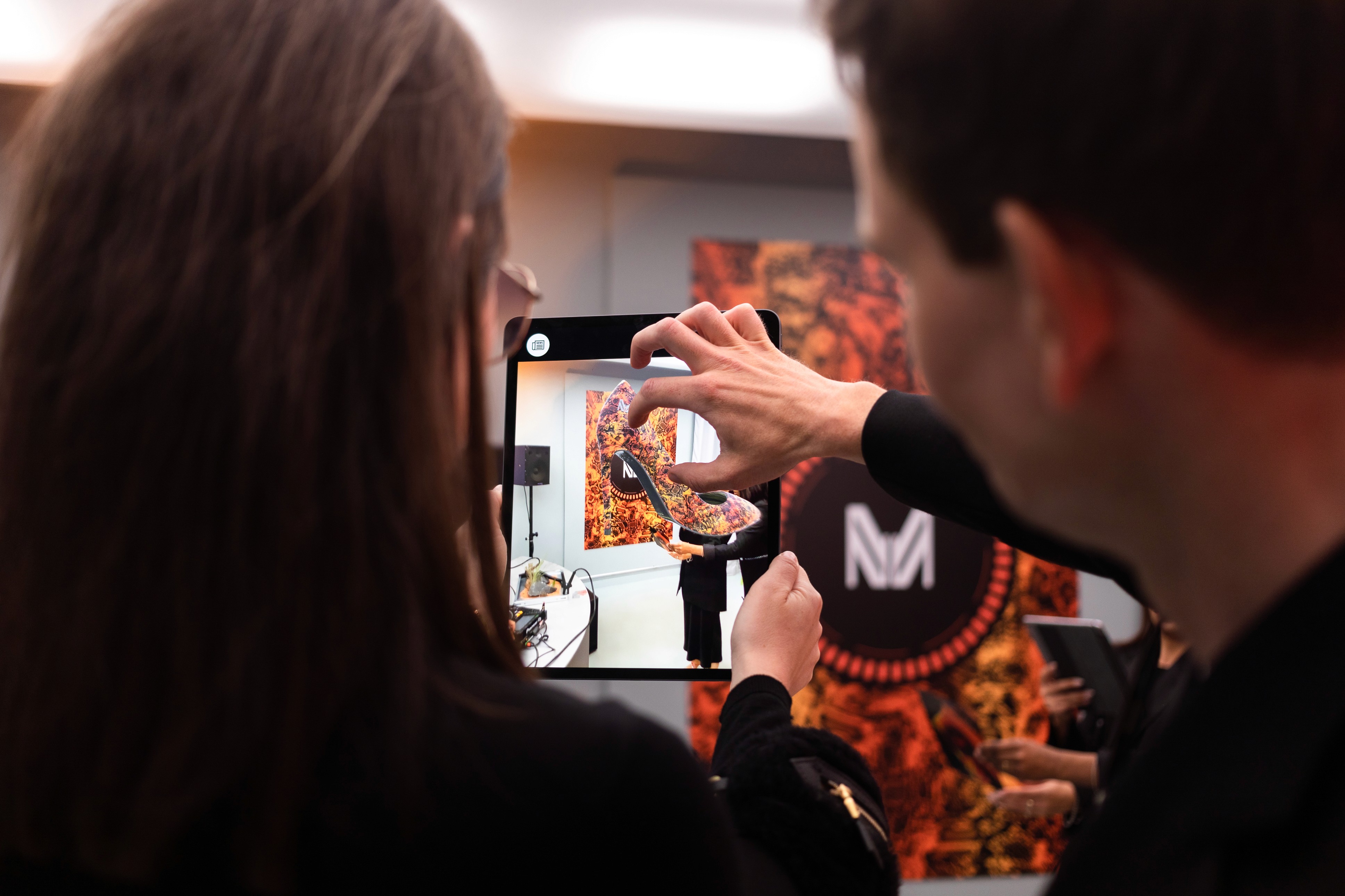 Visitors exploring an AR experience on a tablet at the Marcell von Berlin event