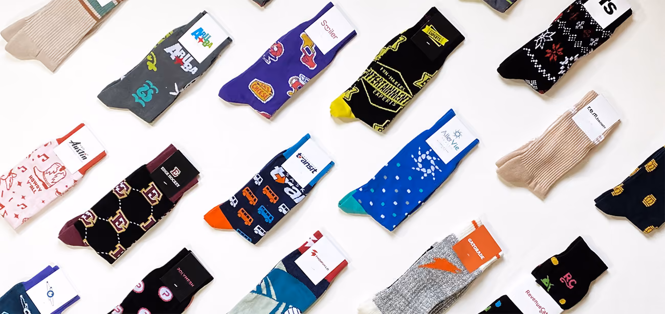 Colorful collection of patterned socks arranged neatly on white background