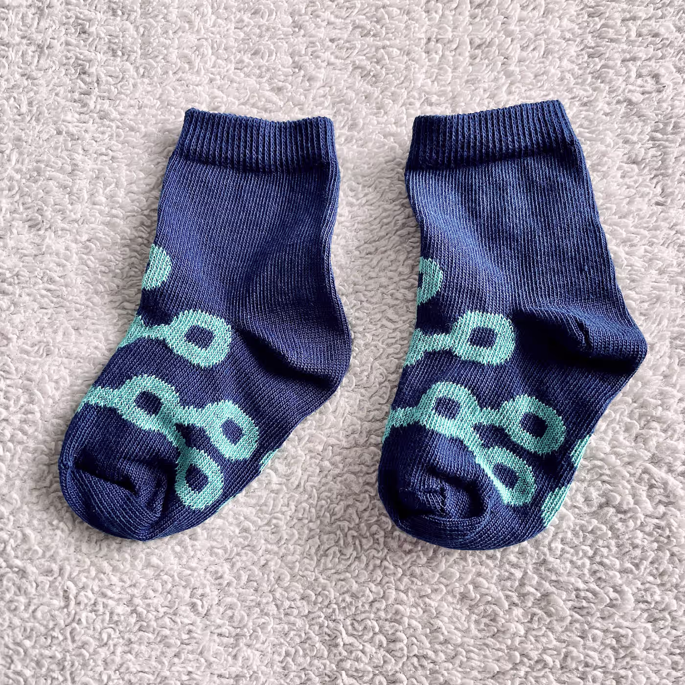 The foot of a man with premium quality green custom dress socks