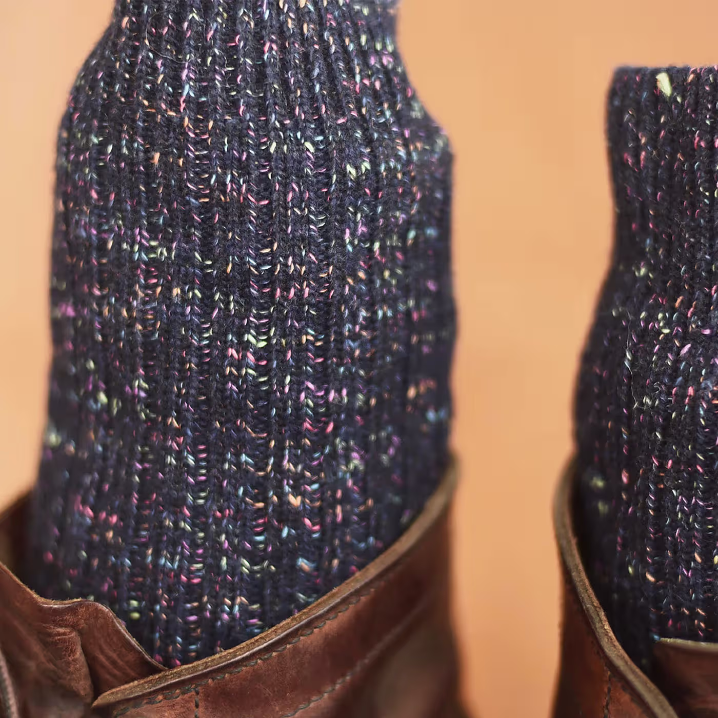 The foot of a man with premium quality green custom dress socks