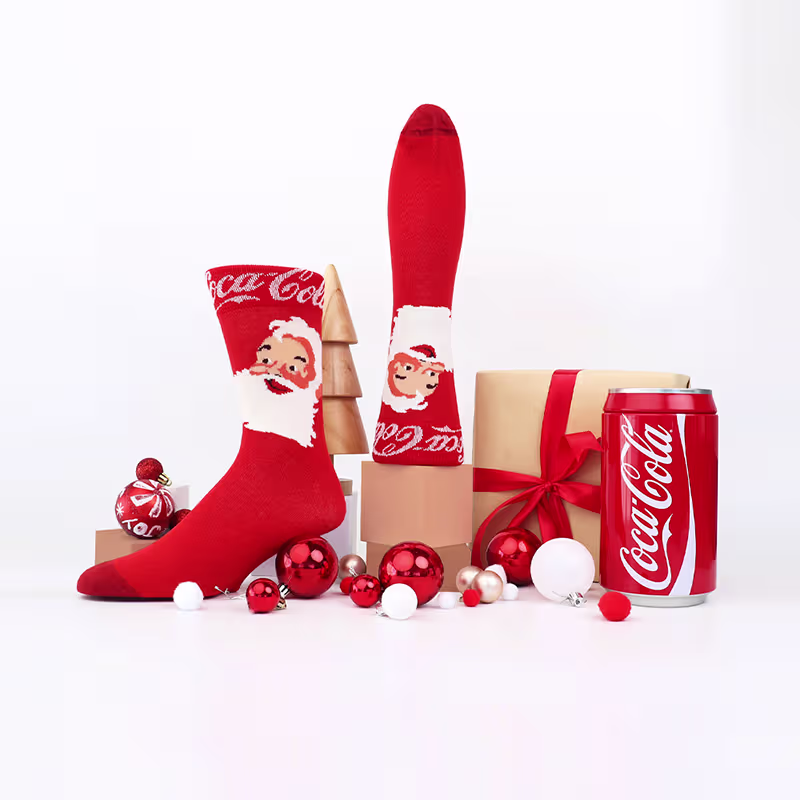 Red custom Coca-Cola Christmas socks with Santa faces, red ornaments, gift boxes, and a Coca-Cola can.