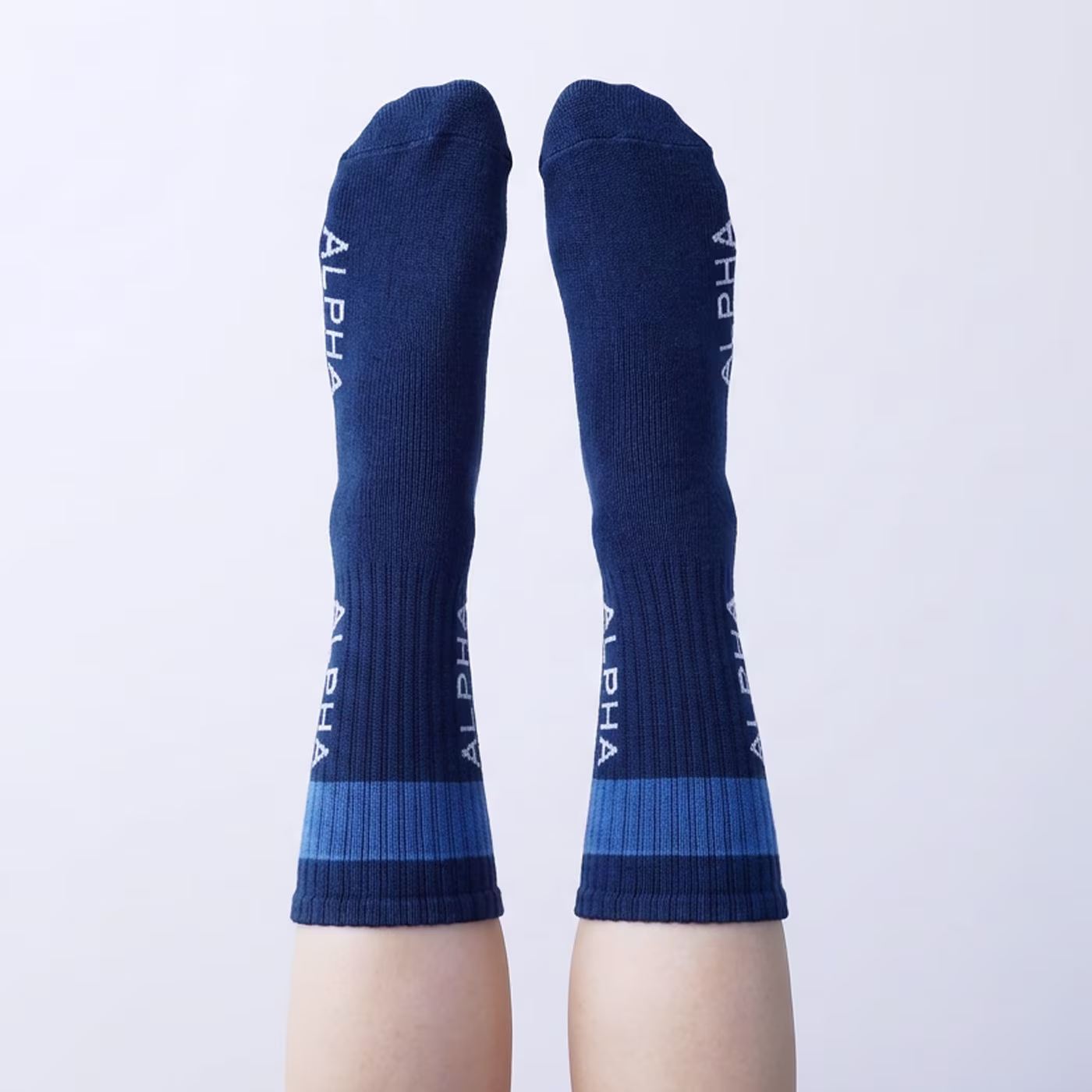 The foot of a man with premium quality green custom dress socks