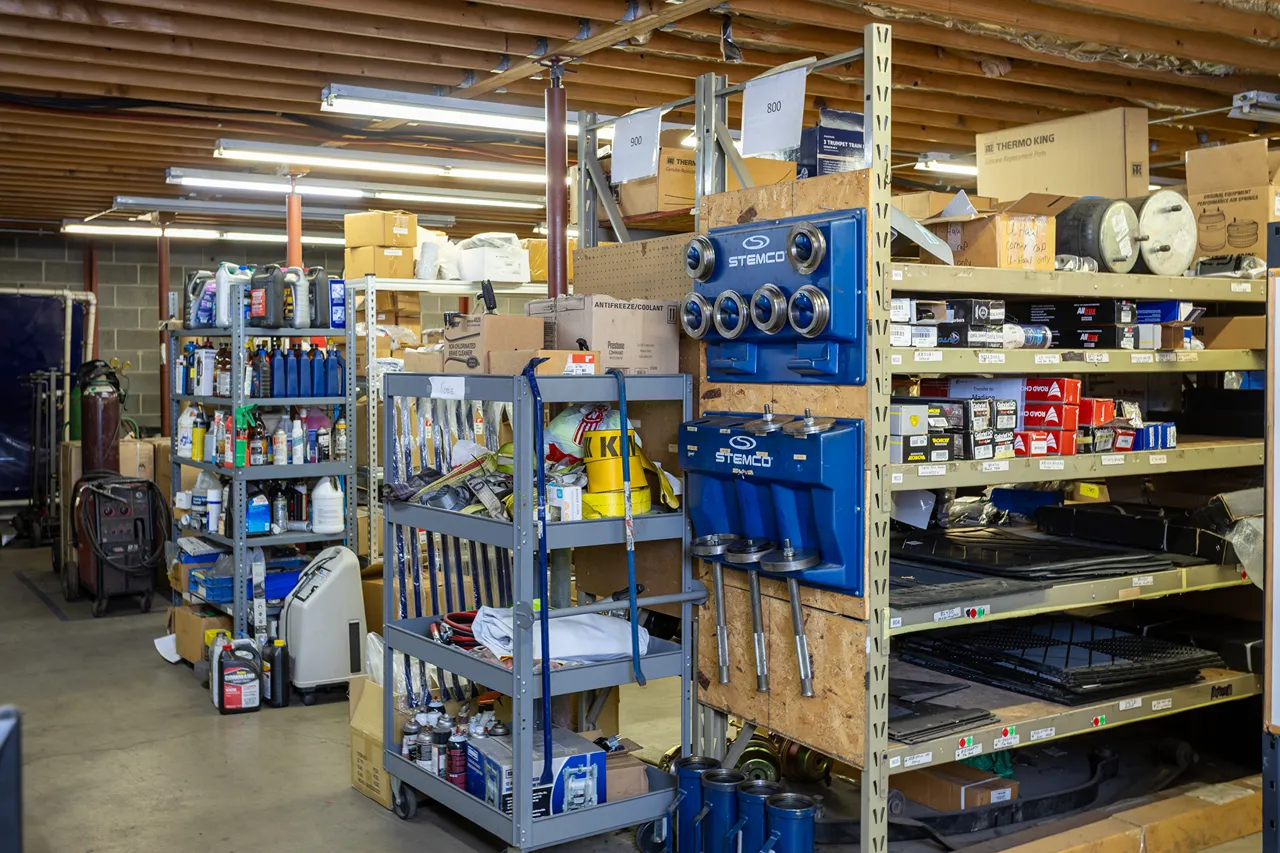 Parts sales inventory with STEMCO components and Thermo King boxes stocked on heavy-duty repair shop shelves.