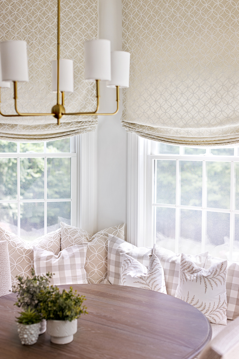 Dining Nook with large windows and soft window treatment with light curtains to lighten the glare and give a soft glow to the nook