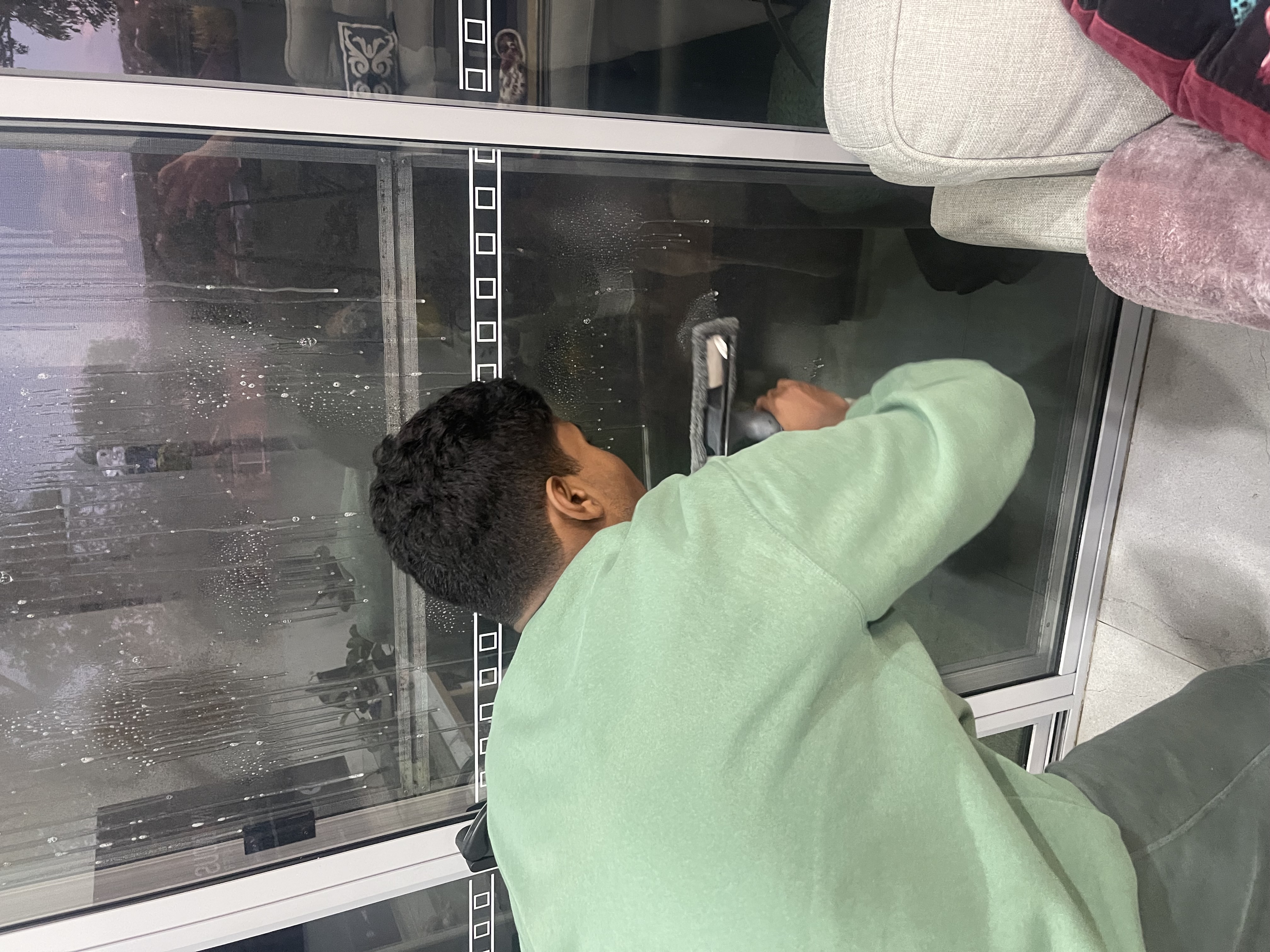 Able to Thrive participant Rayan tidying up at home in Sydney with NDIS SIL support