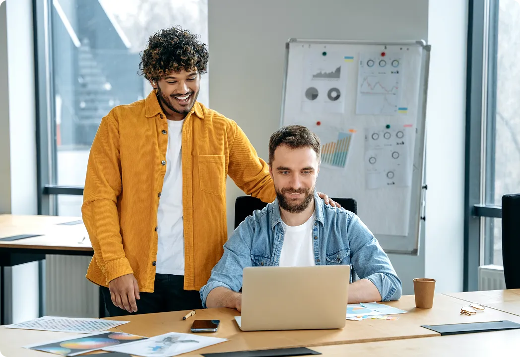 hree men collaborating at a table, writing and discussing something in a marketing agency.