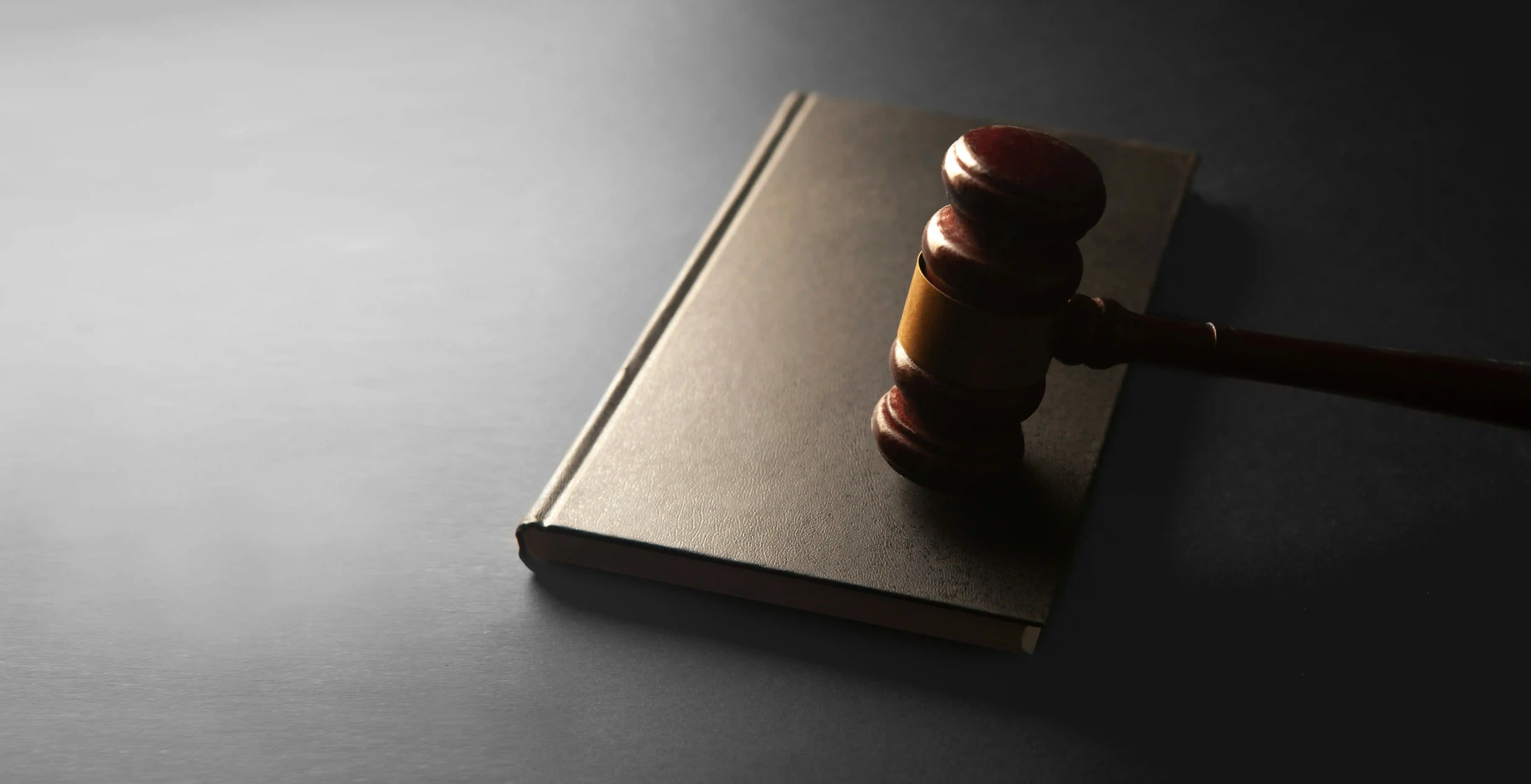 a judge's gavel on a dark background.