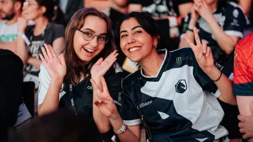 Team Liquid fans posing and smiling for the camera in an e-sports event.