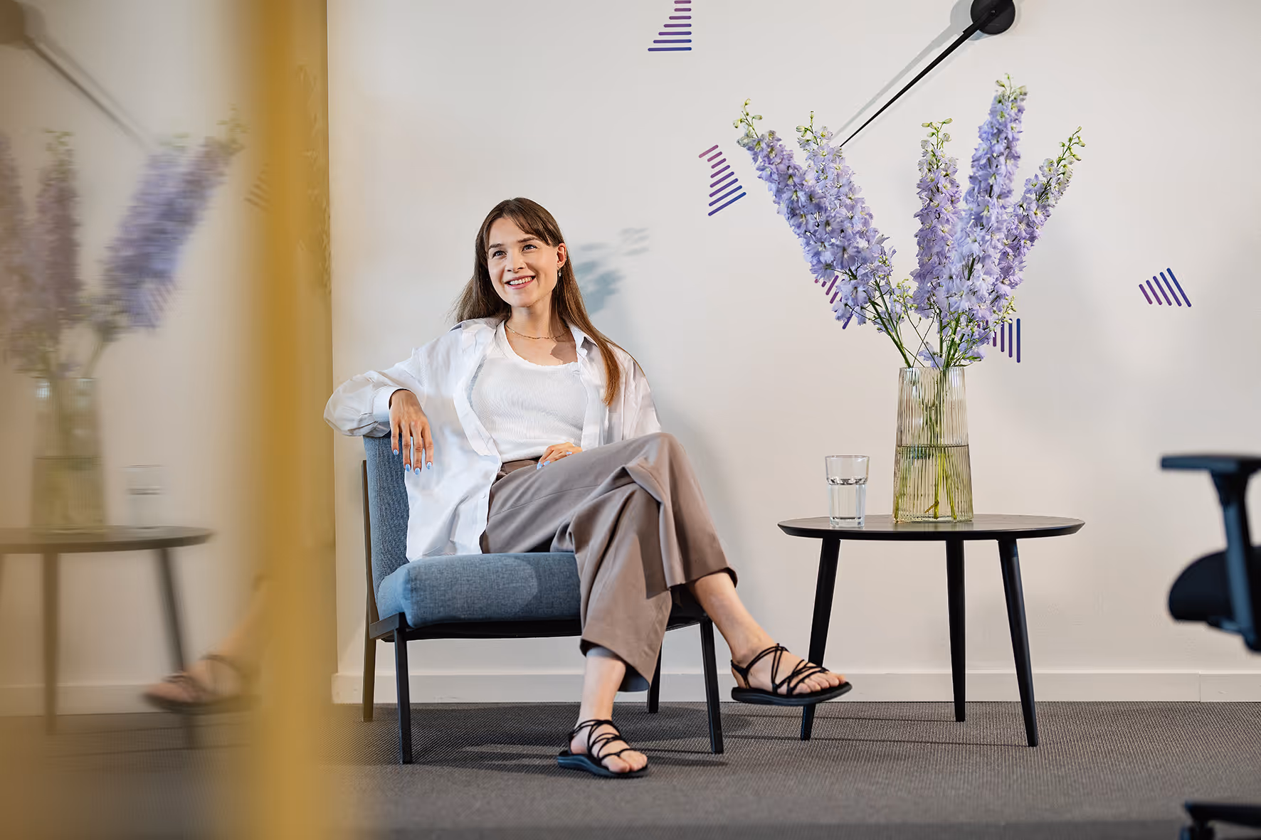 Gabriela sitting on a chair smiling