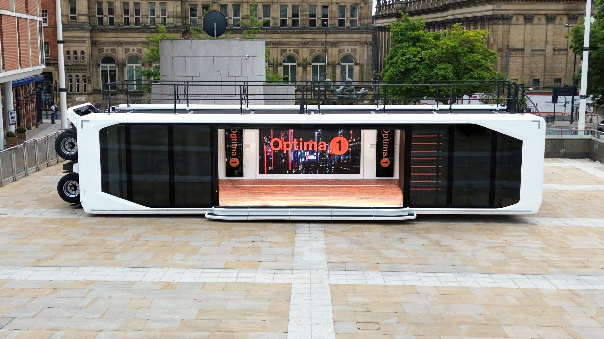 Outside of an Expandable podcast trailer near a building