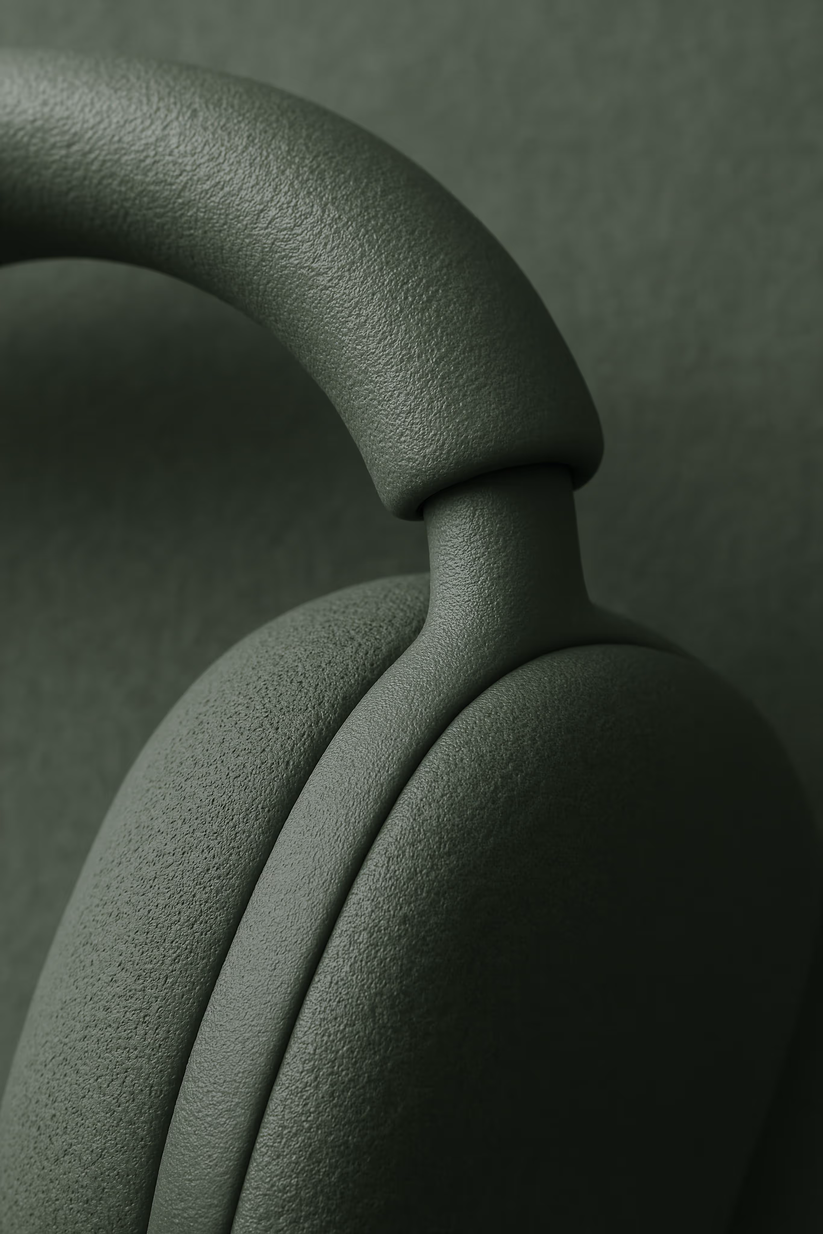 Close-up of textured green headphones focusing on the ear cup and headband connection.