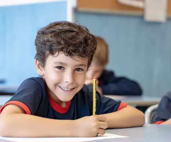 Young girl practising Arabic writing in class