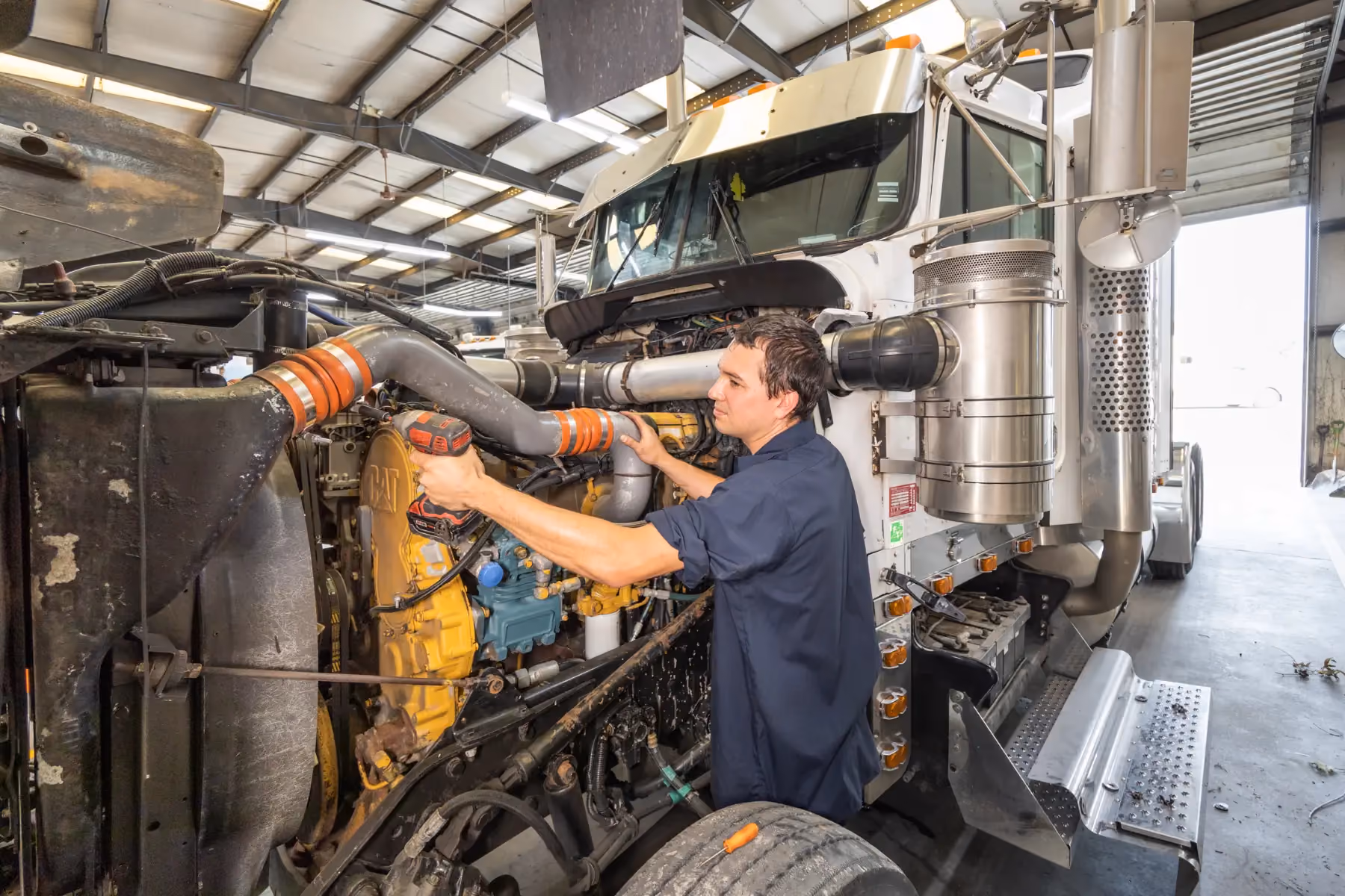 Diesel mechanic performing preventive maintenance services on semi truck in Fredericksburg, Virginia