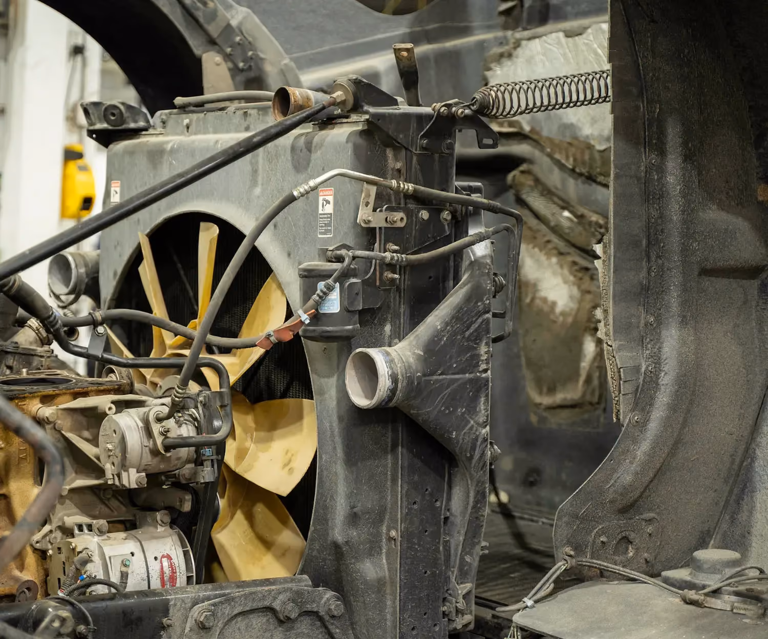 Diesel mechanic performing coolant system repair on semi truck in Fredericksburg, Virginia