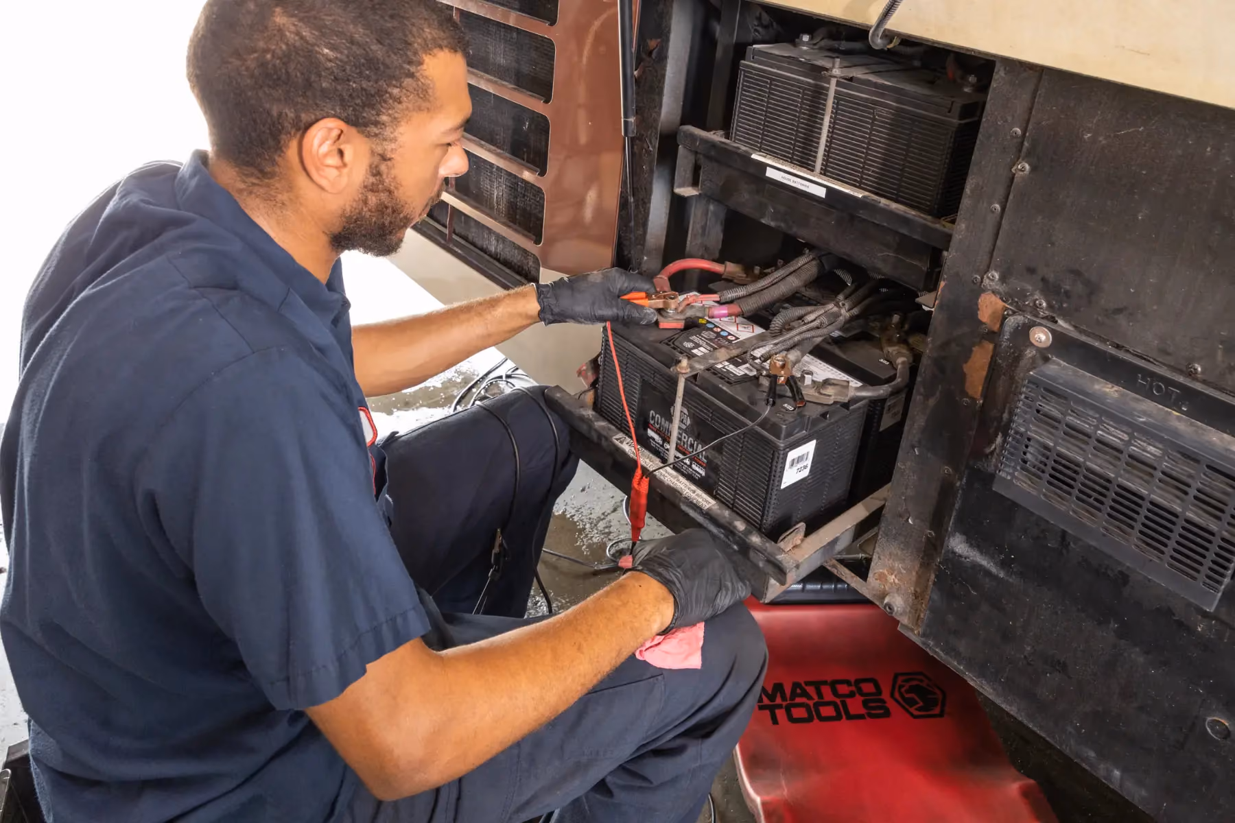Diesel mechanic performing electrical repair on semi truck in Fredericksburg, Virginia