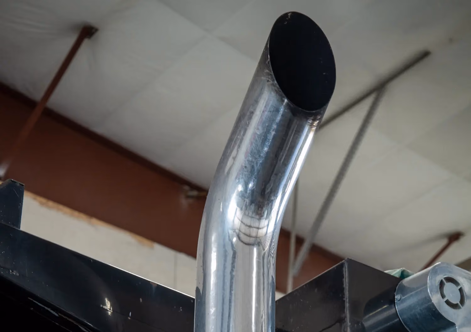 Diesel mechanic performing exhaust system repairs on heavy-duty truck in Fredericksburg, VA