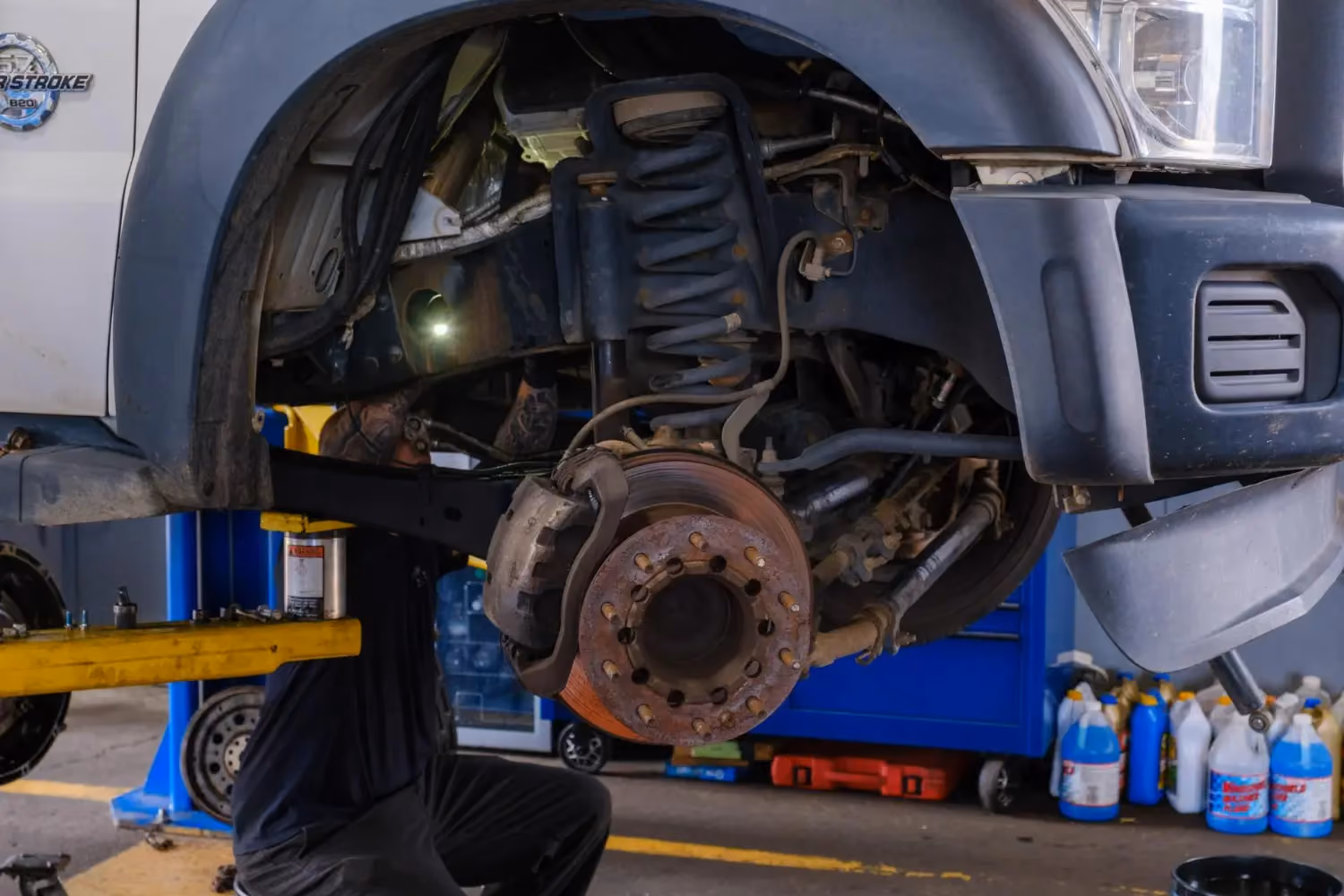 Diesel mechanic performing suspension repairs on commercial truck in Fredericksburg, VA