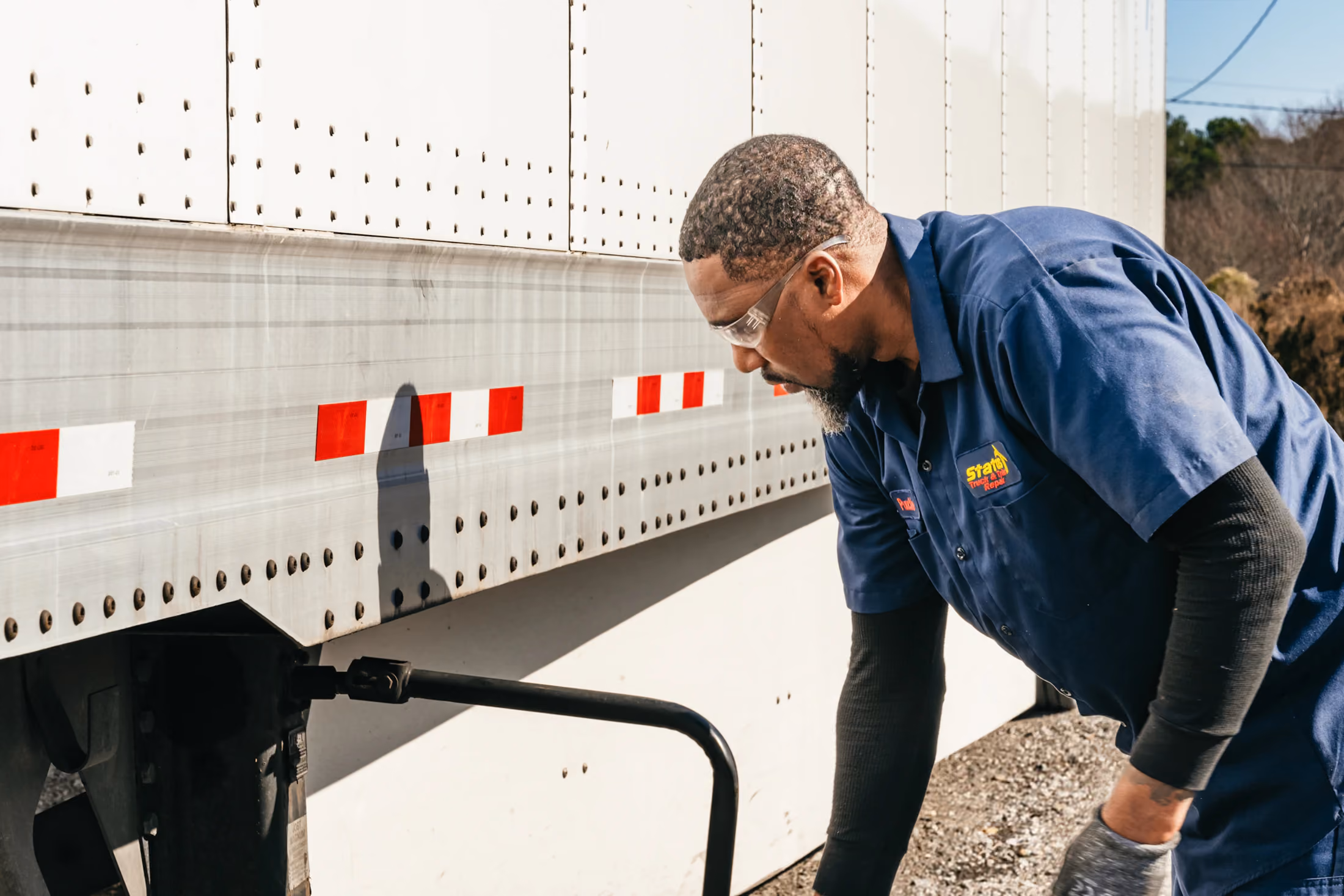 Diesel mechanic performing DOT inspection on semi truck in Fredericksburg, Virginia