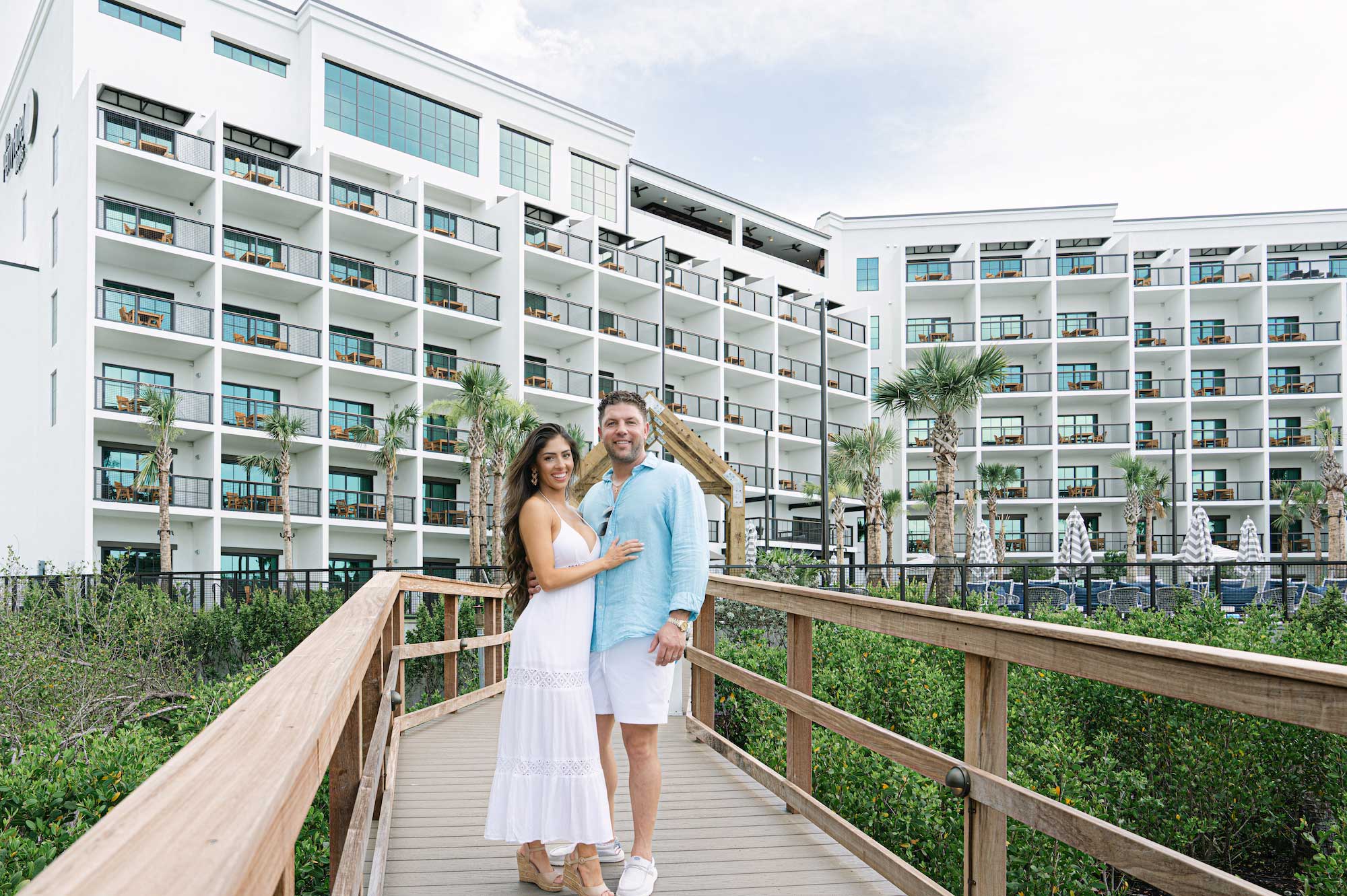 Couple smiling in front of the Perry Hotel