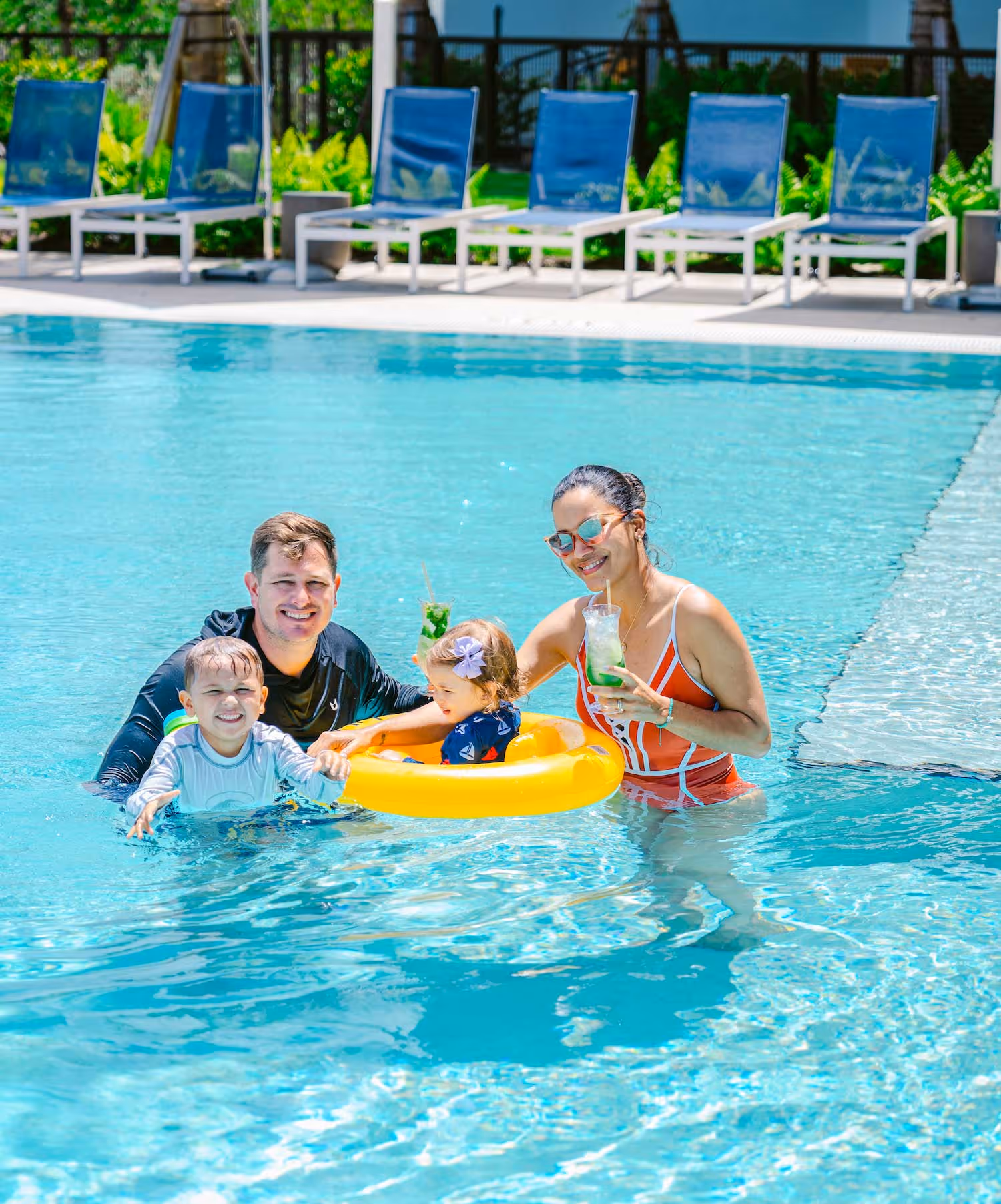 Family of 4 having fun in the pool