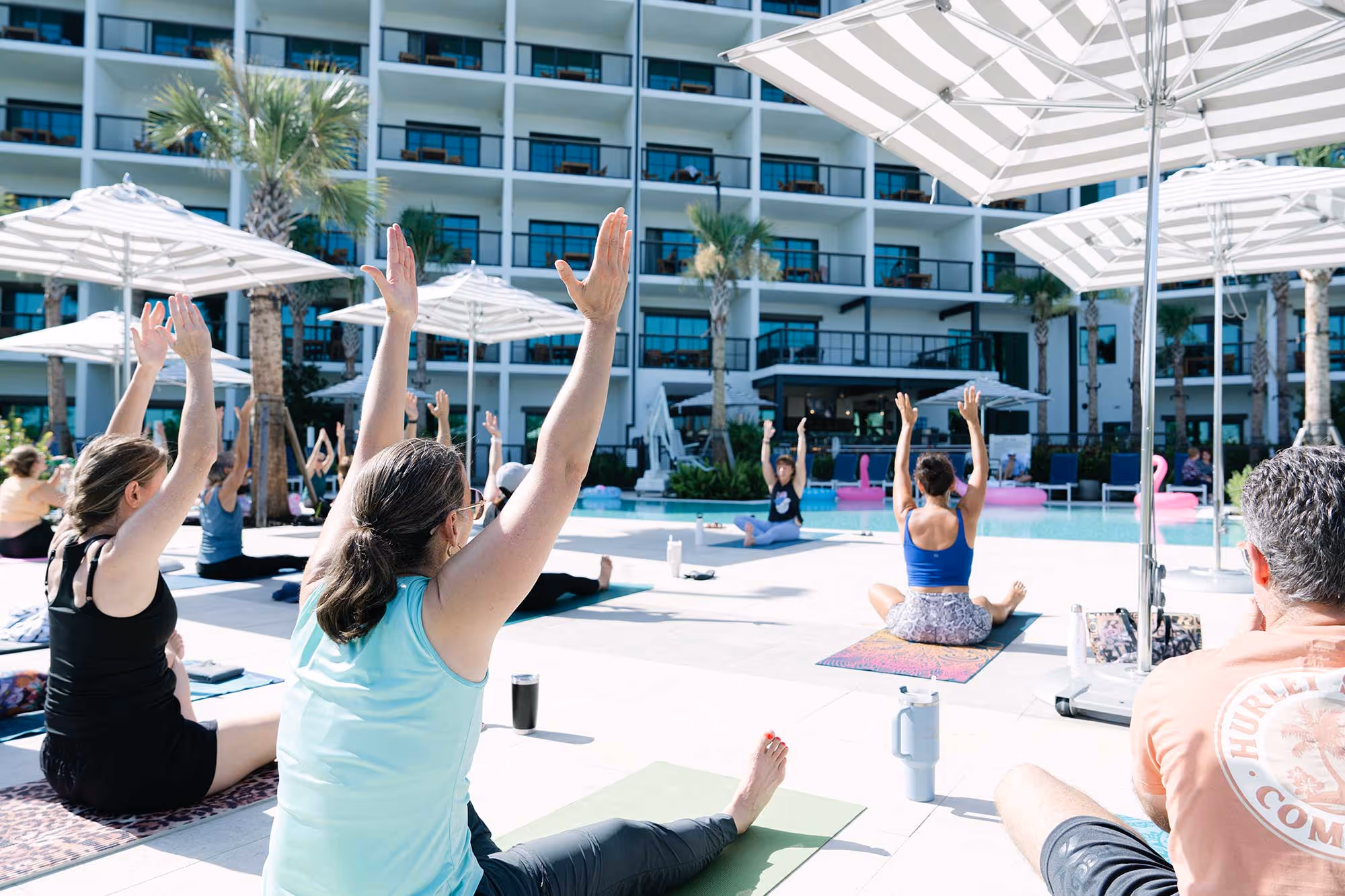 People doing yoga in front of the Perry Hotel