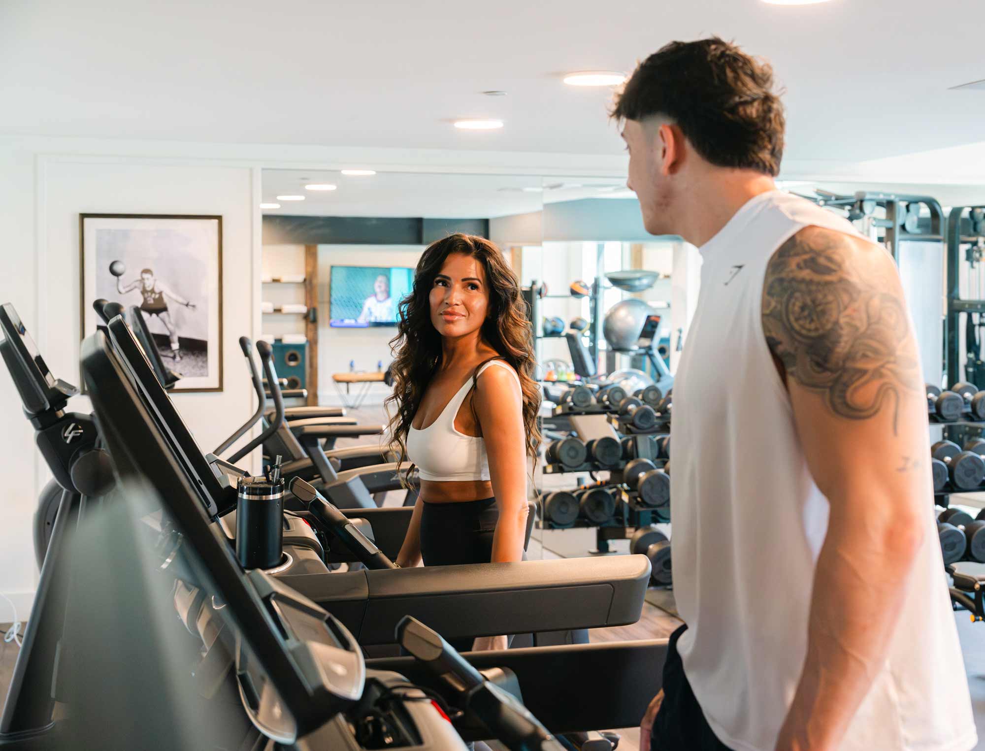 Couple embracing on balcony overlooking lush river landscape