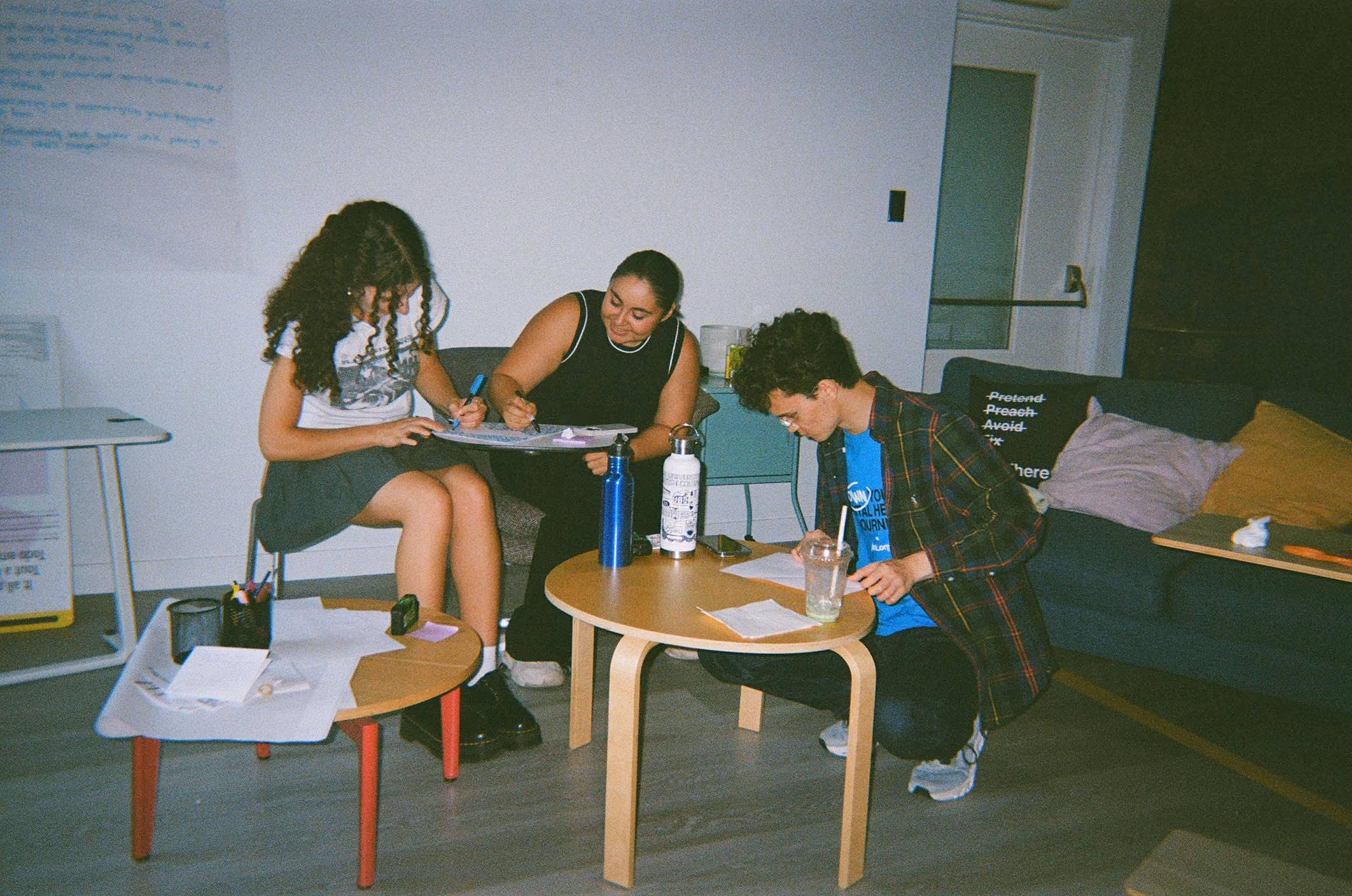 A group of students working on a project on uneven desks