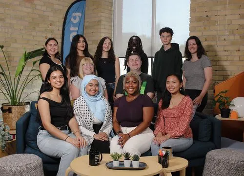 Participants posing around a table in casual clothes in the jack.org office