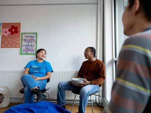 Three young people gathering in community