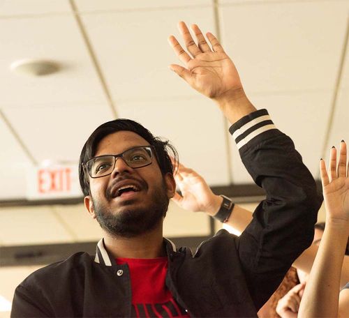 participant raising their hand indoors