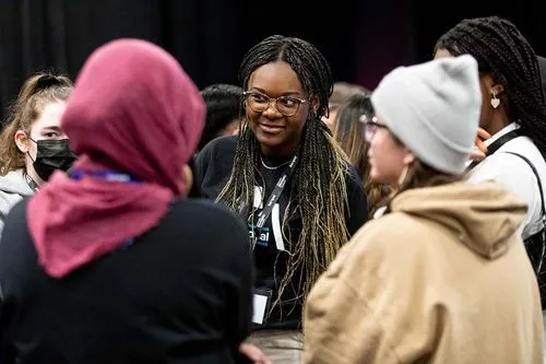 3 participants discussing with each other with two other people