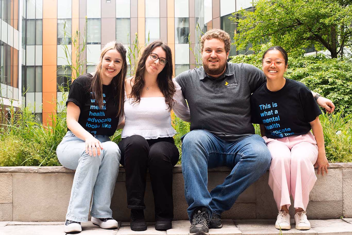 Group photo of students sitting on bench outdoors