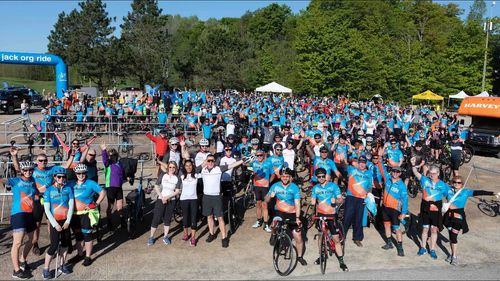 large group of jack riders outside with bikes during a jack ride event