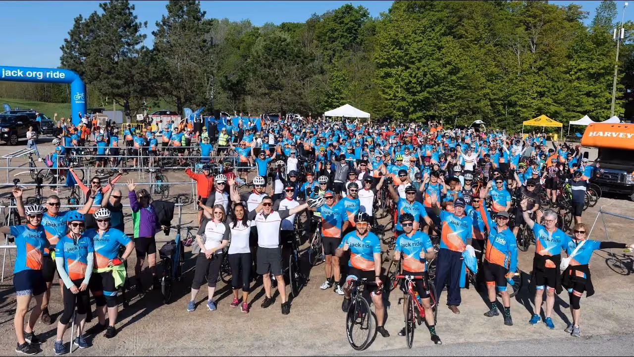large group of jack riders outside with bikes during a jack ride event