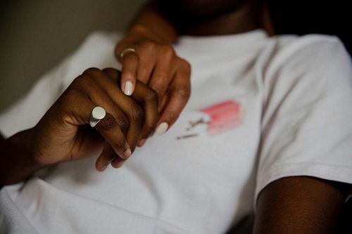 Hand holding on top of a shirt