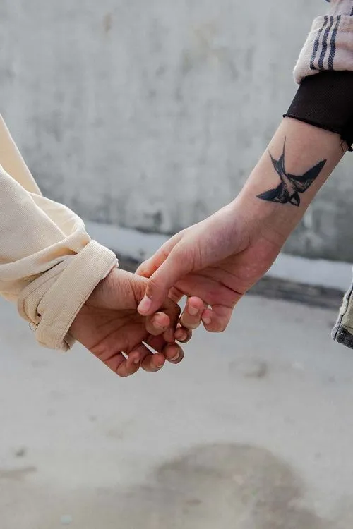 picture of two hands being held. young