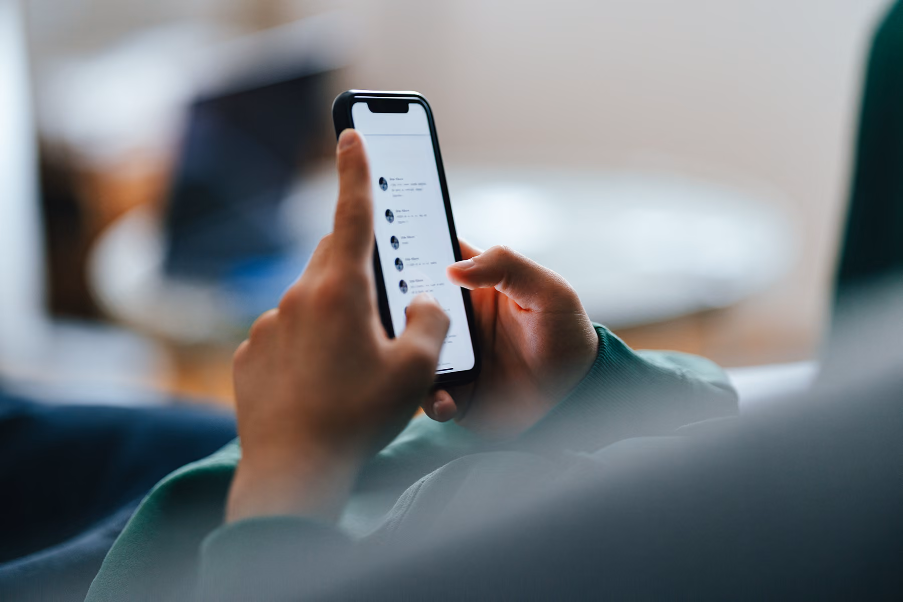 Close up of hands looking at a phone