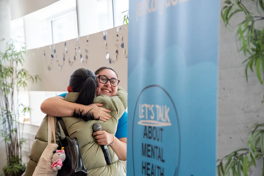 two participants hugging