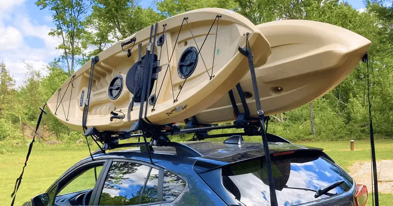 two kayaks attached to vehicle roof rack