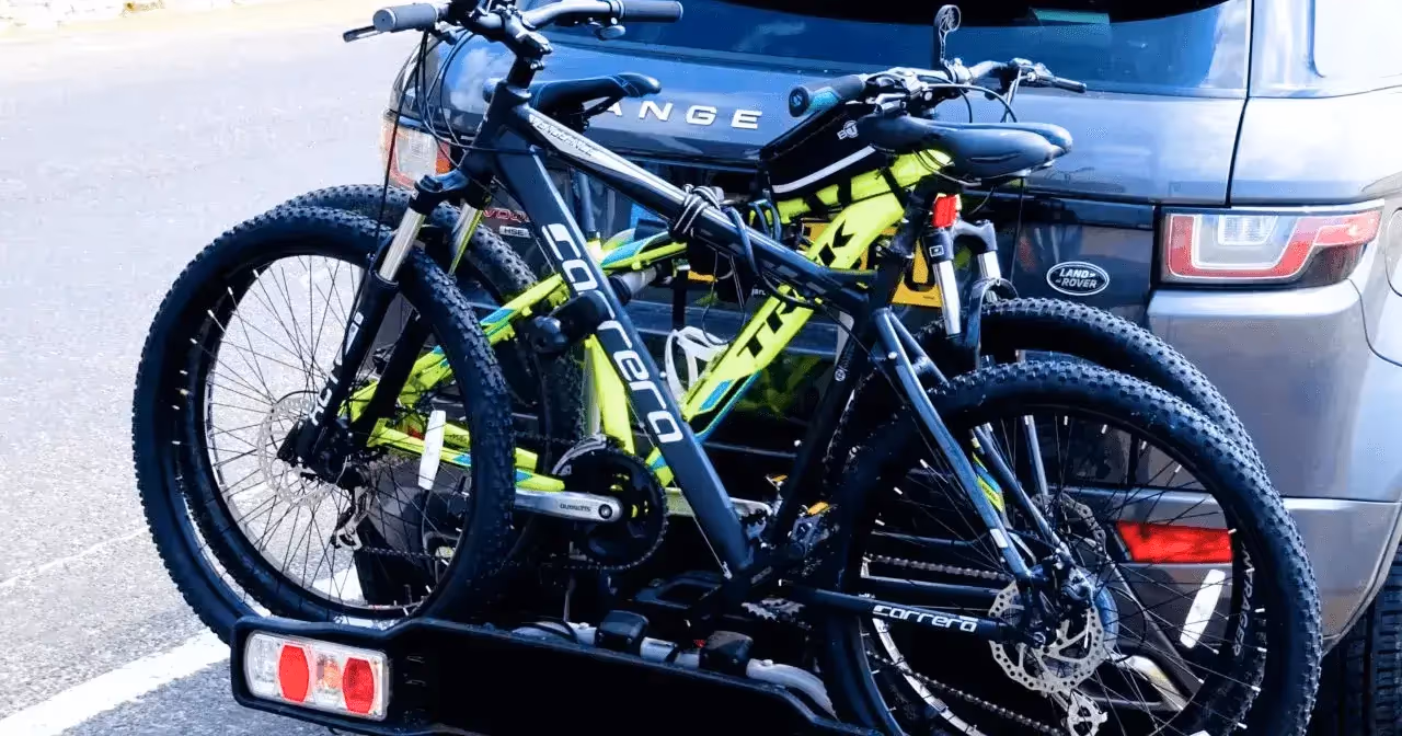 two mountain bikes secured to hitch rack