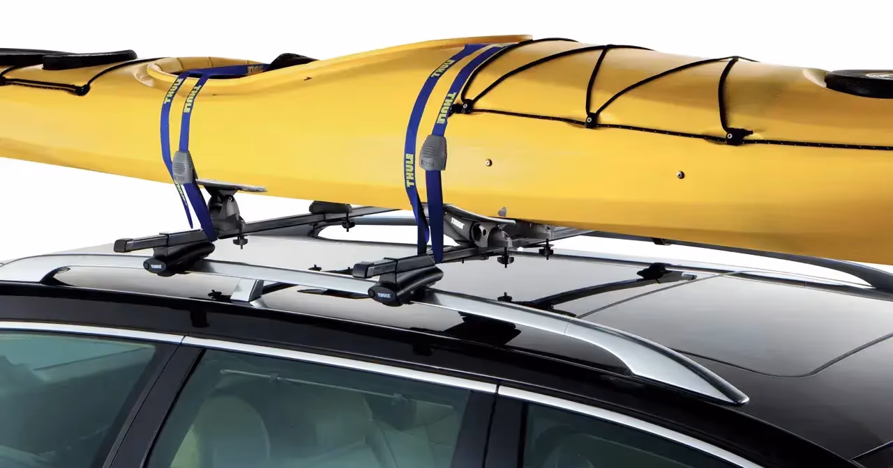 yellow canoe mounted to horizontal saddle roof rack