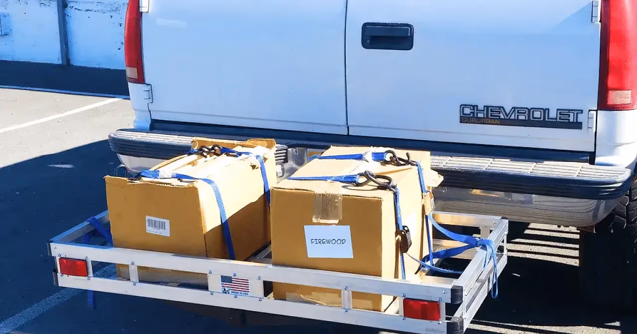 hitch cargo carrier with two boxes behind white Chevrolet van