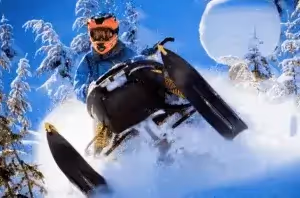 person snowmobiling in a fresh powder