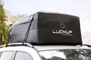 vehicle with box top carrier strapped to roof