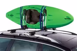 green kayak strapped to high-capacity vehicle roof rack