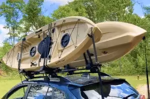 two kayaks attached to vehicle roof rack