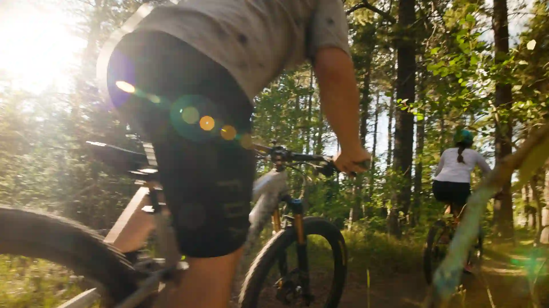 Mountain bikes on Casper Mountain with sun breaking through, part of a Checked In Media video production advertisement for Hilltop Bank by a Casper Wyoming advertising agency.