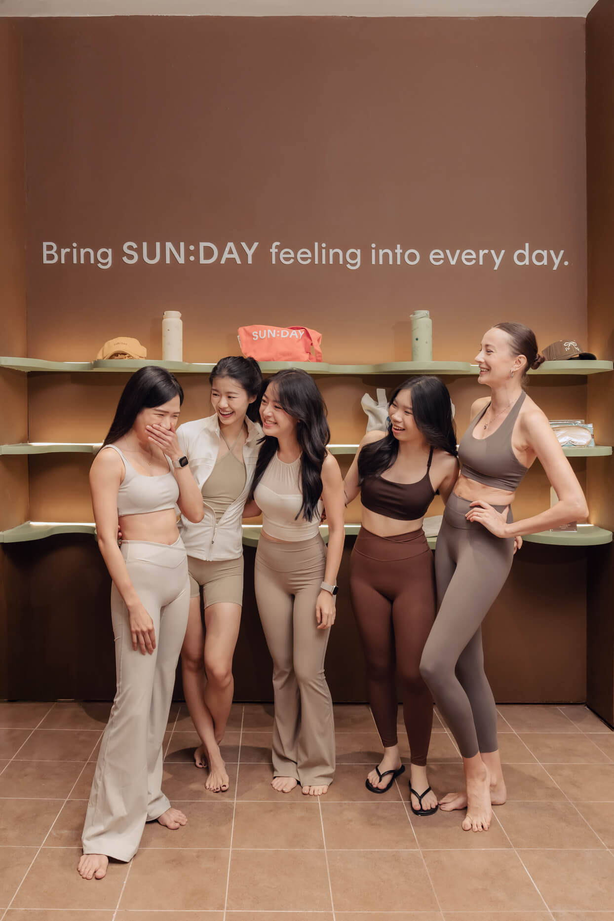 The SUN:DAY Pilates team sharing a moment together in the studio.