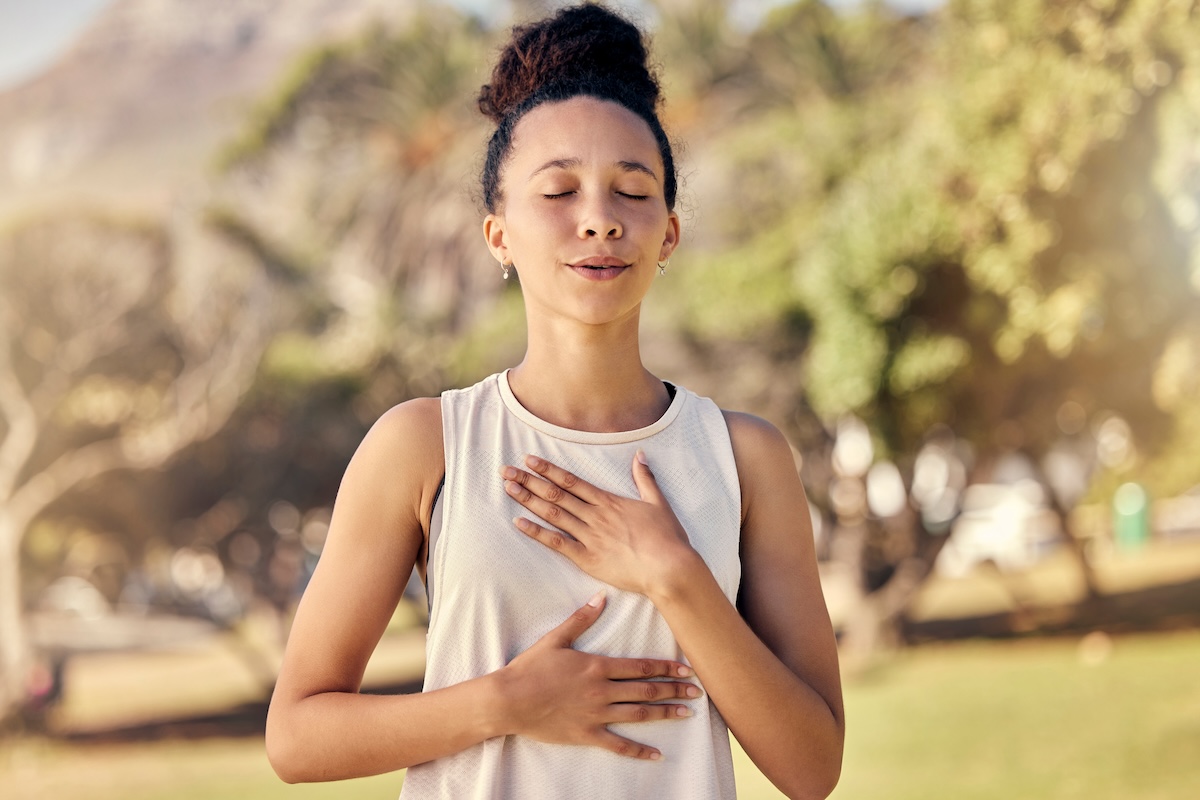 Practising breathwork outdoors in a park