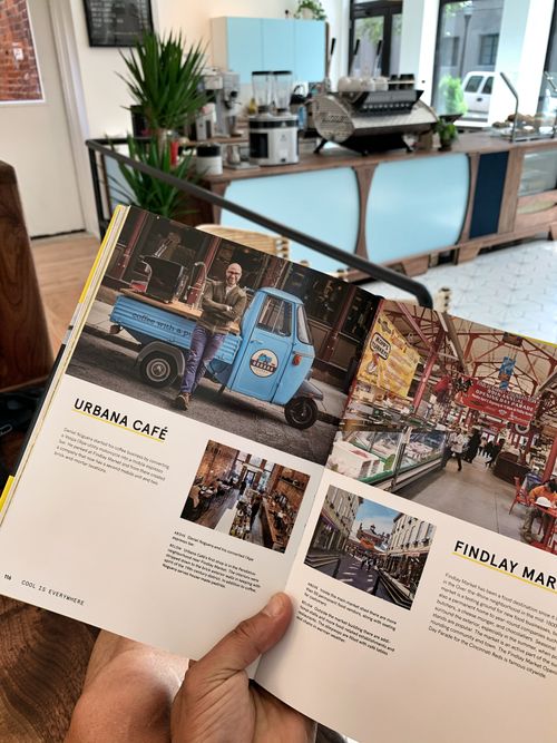 Magazine feature of a mobile espresso bar with a blue Italian Vespa scooter